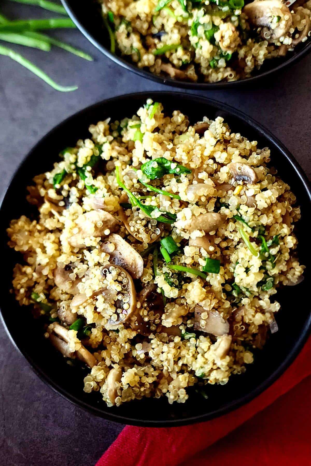 Two bowls of mushroom spinach quinoa.