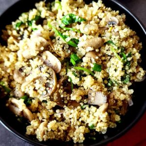 Mushroom quinoa served in a black bowl.