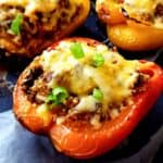 Mushroom stuffed peppers on a baking tray.