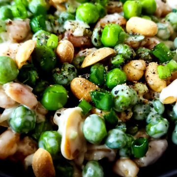 Pea and peanut salad sprinkled with crushed black pepper.