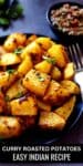 Curry roasted potatoes served on a plate with a fork.