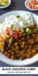 Black chickpea curry and rice served in a white bowl.
