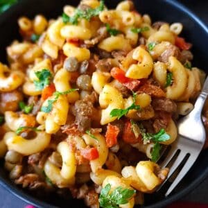 Closeup shot of lentil pasta in a bowl with a fork.